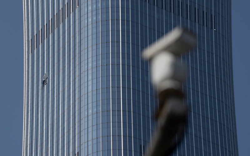 A small plane has crashed into a Beijing high-rise, killing the pilot and injuring 13