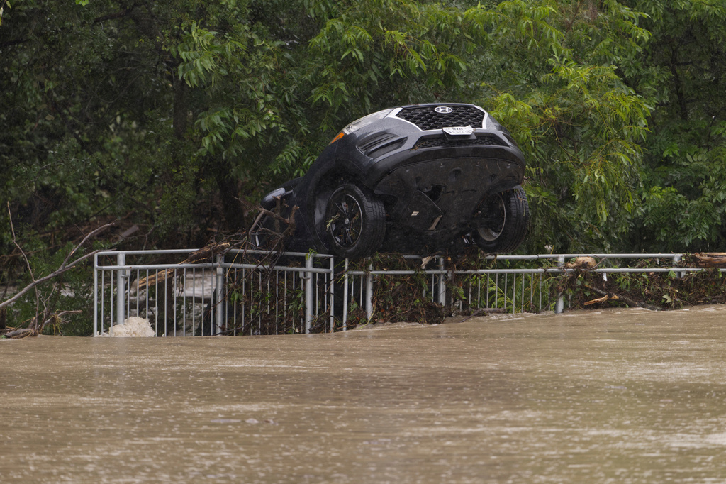 Texas flooding surges from huge rainstorms as rescuers pull people from rising waters
