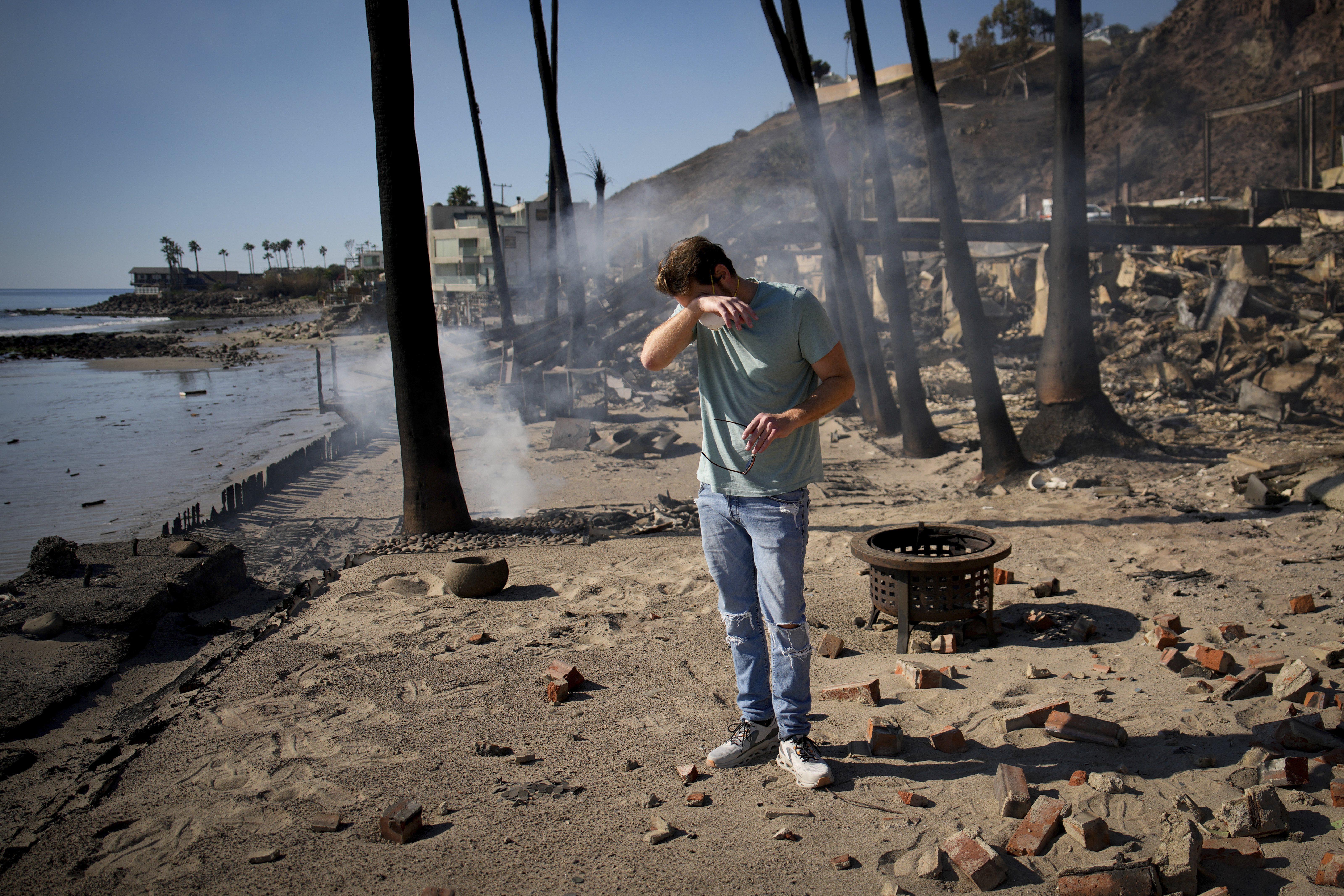 With their Los Angeles-area homes still smoldering, families return to search the ruins for memories