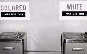 Segregated water fountains (B&W photo)